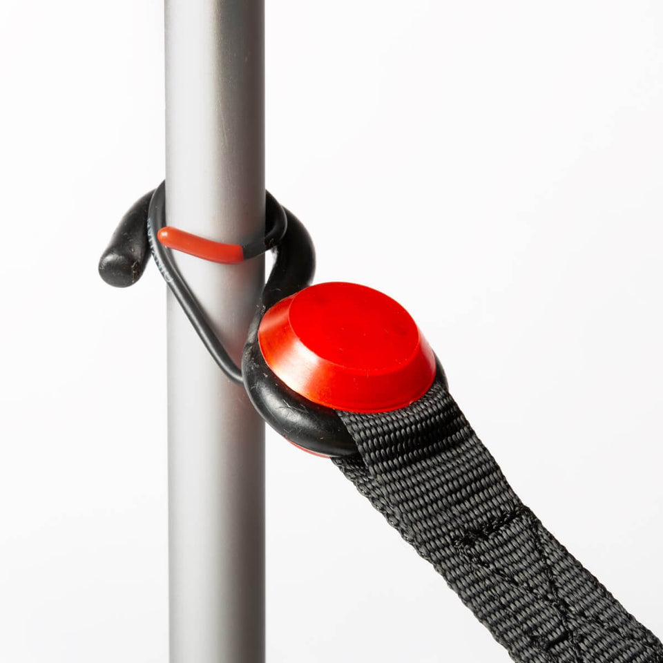 The OmegaStrap ratchet strap secured to an anchor point via patented flexible hook.